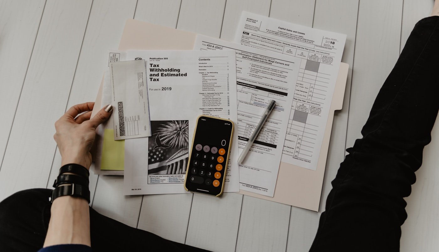 Financial documents and a calculator arranged on a desk