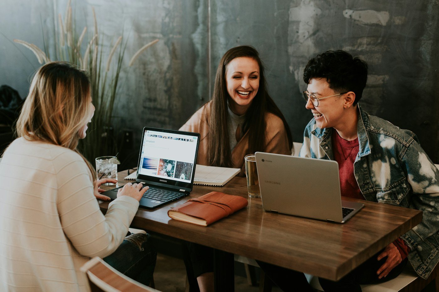 A small team working together around a laptop