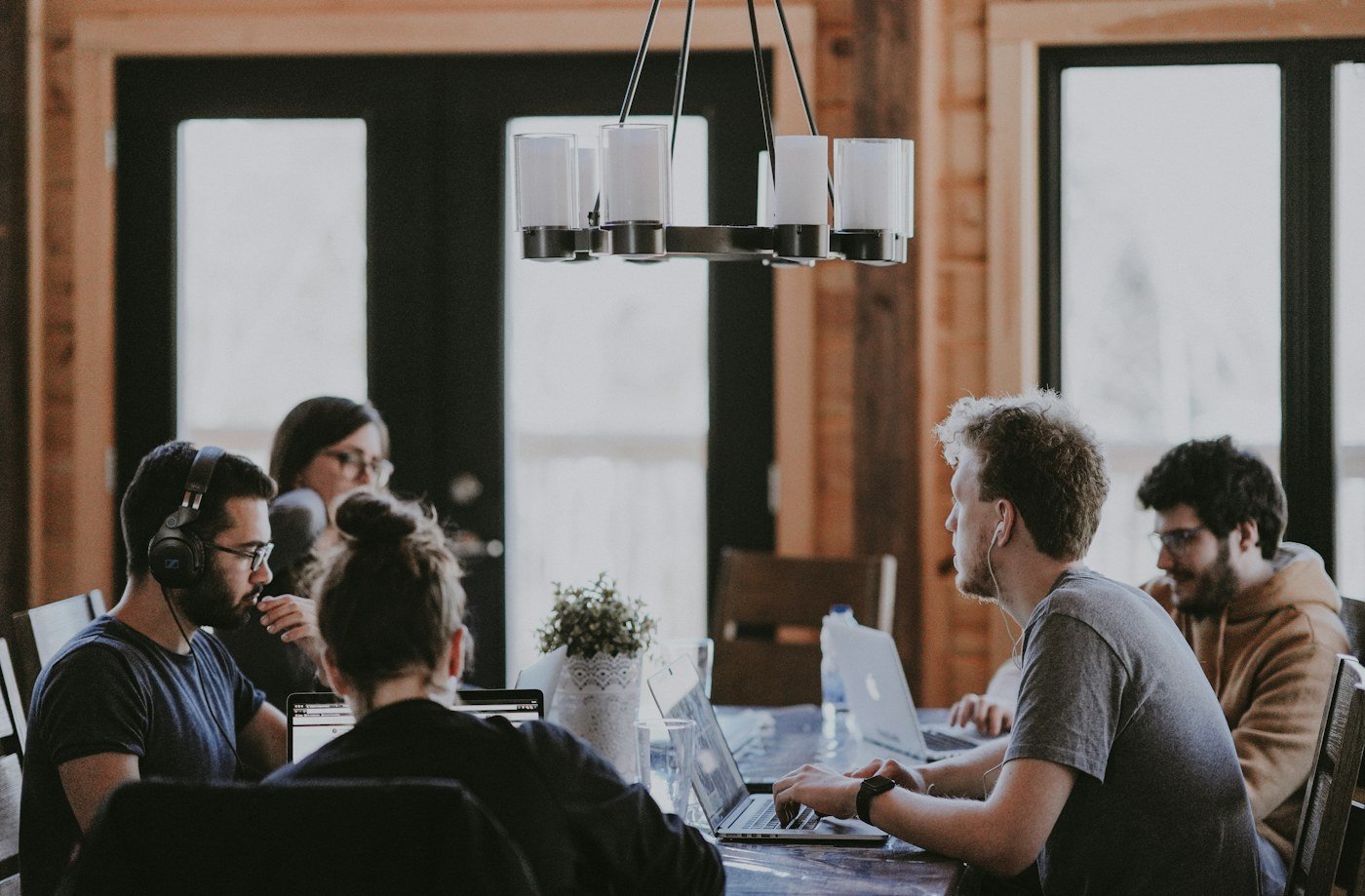 A small business team sharing ideas around a laptop